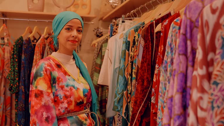 MS portrait smiling female business owner standing in clothing boutique